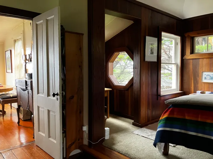The garden room with redwood panelling and an octagonal window