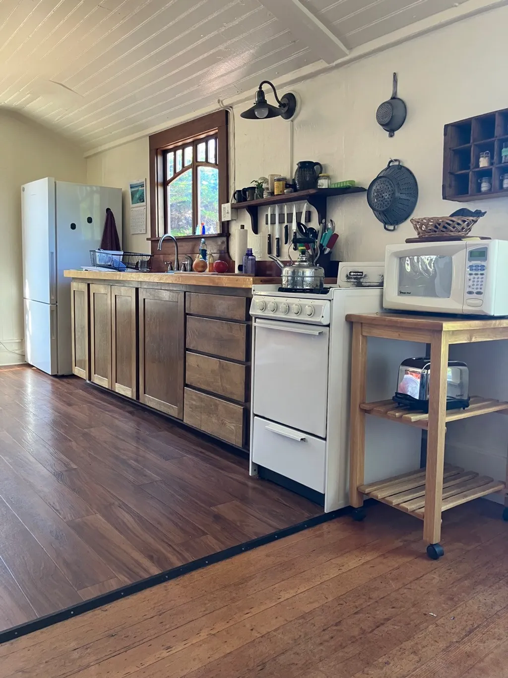 The kitchen's modern range, refrigerator, and microwave