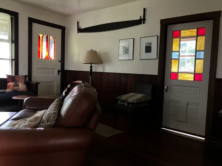 Old stained glass throwing colour across the sitting-room floor